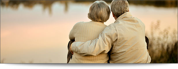 Retired couple looking over a pond.